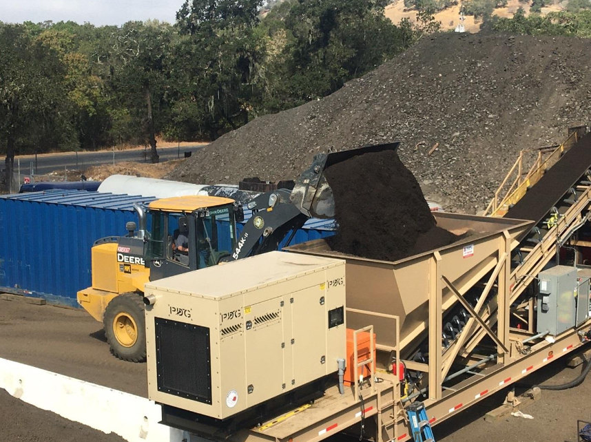 Load aggregate for ambient temperature paving for brownfield site remediation